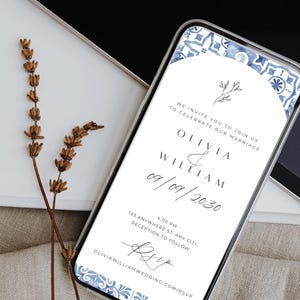 May include: A mobile phone screen shows a wedding invitation with a blue and white tile pattern. The invitation features the names Olivia and William, the date 09/09/2030, and RSVP details. Dried lavender sprigs are in the background.