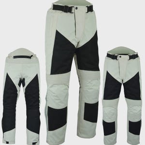 May include: Three pairs of off-white and black motorcycle trousers featuring a high-waisted design with an adjustable black belt at the waist. The trousers include black panels on the thighs and lower legs, with ribbed detailing above the knees.