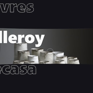 May include: A collection of white ceramic pitchers and vessels with textured, uneven surfaces arranged in a group. The text Villeroy is displayed in large white letters above the ceramics, with Sèvres and Becasa in outlined text.