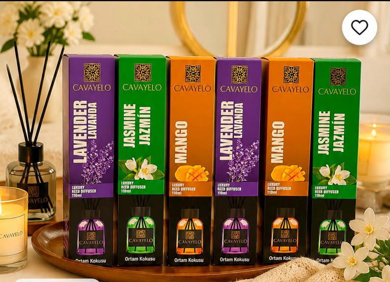 May include: Six rectangular boxes of Cavayelo luxury reed diffusers in 110ml sizes, arranged in a row. The boxes feature purple, green, and orange colors with lavender, jasmine, and mango illustrations, along with the brand name and scent labels.