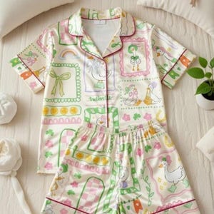 Relax in whimsical charm with this Cute Goose pajama set, featuring adorable duck and goose illustrations dressed with bows, boots, flowers, and lucky green details. Inspired by coquette, cottagecore, and playful St. Patrick’s Day vibes, this design feels soft, dreamy, and cozy.