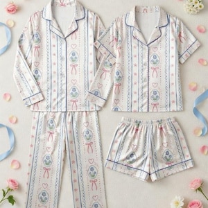 Step into a world of romantic dreams with our Vintage-Inspired Coquette Pajama Set. Featuring a delicate pattern of blue florals, pink ribbons, and dainty hearts, this set is designed for the woman who loves a touch of " (classy/luxurious) even while she sleeps.
