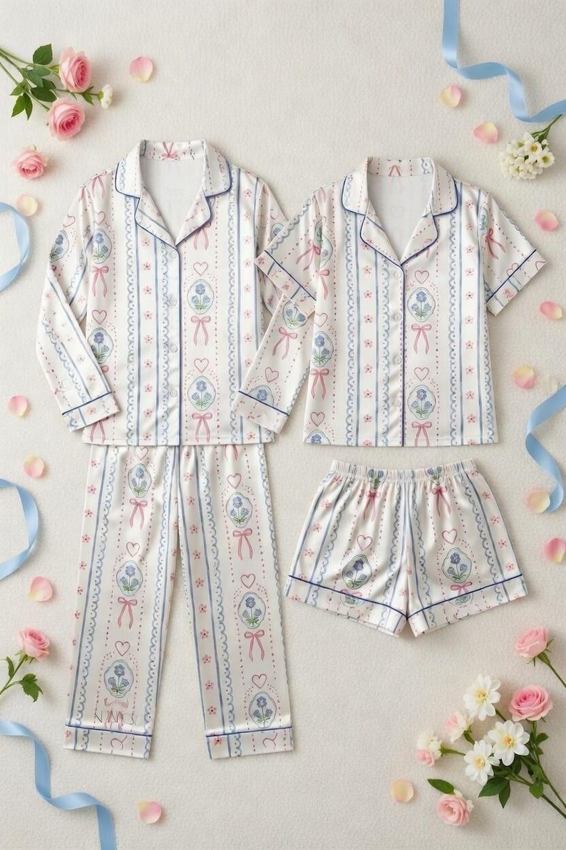 Step into a world of romantic dreams with our Vintage-Inspired Coquette Pajama Set. Featuring a delicate pattern of blue florals, pink ribbons, and dainty hearts, this set is designed for the woman who loves a touch of " (classy/luxurious) even while she sleeps.