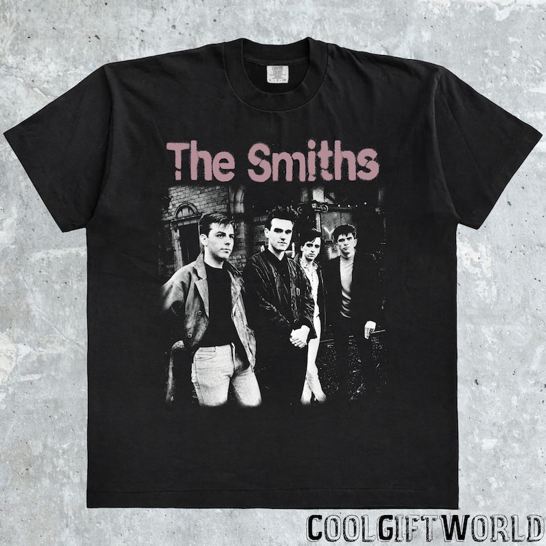 May include: Black t-shirt featuring the band "The Smiths" with a faded pink text. The image on the shirt shows the band members in black and white. The text "COOLGIFTWORLD" is at the bottom of the shirt.