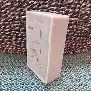 May include: A set of three ceramic mugs with a speckled, matte finish. The mugs are in shades of cream, light gray, and dark gray. Each mug has a simple, minimalist design, perfect for coffee or tea.