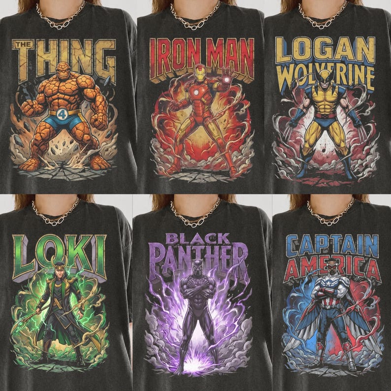May include: A collection of six charcoal grey t-shirts featuring graphic prints of Marvel characters including The Thing, Iron Man, Logan Wolverine, Loki, Black Panther, and Captain America, each with bold text and dynamic action scenes.