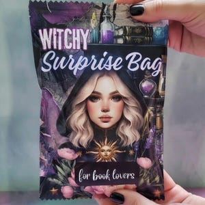 May include: A purple and black "Witchy Surprise Bag" with a portrait of a woman with blonde hair and a black hood. The bag features the text "for book lovers" and illustrations of potion bottles, books, and flowers.