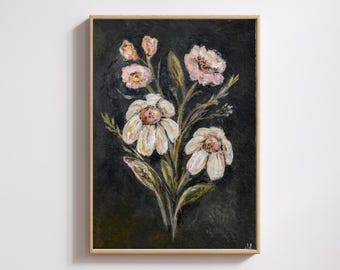 May include: A framed floral painting featuring white and pink flowers with green leaves against a dark background. The artwork is in a light-colored wooden frame, creating a contrast with the dark backdrop.