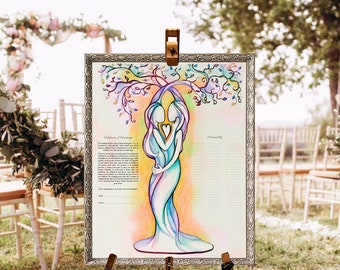 May include: A rectangular certificate of marriage in a silver ornate frame featuring a colorful illustration of two figures embracing under a stylized tree. The artwork uses pastel watercolor tones and includes printed text and signature lines.