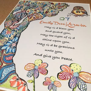 May include: A colorful, hand-drawn illustration of a tree with a whimsical owl perched on a branch. The text reads "Emily Dove Korvin" and includes a blessing: "May G-d bless you and guard you, May the light of G-d shine upon you. May G-d be gracious unto you. And give you Peace."