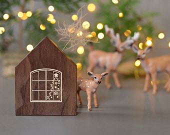 Holiday decor, small wooden house with window and Christmas tree, minimalist elegant holiday decoration