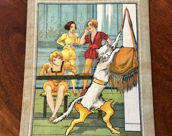 May include: Vintage print of "Le Chat Botté" (Puss in Boots) featuring illustrations of characters in period clothing. The artwork includes a large white cat with yellow accents, and three figures in yellow and red outfits. The print has text in French.