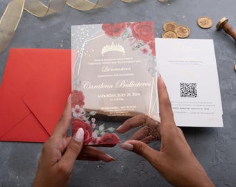 May include: A clear acrylic Quinceañera invitation with red rose floral accents and gold geometric design. The invitation includes event details and the name "Caralena Ballesteros". A red envelope and additional cards are also visible.