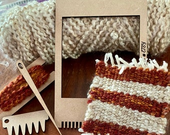 May include: A wooden loom with a white and brown woven tapestry in the frame. The loom has a comb and a needle for weaving. The tapestry is striped with white and brown yarn. The loom is labeled "Etsy 328".