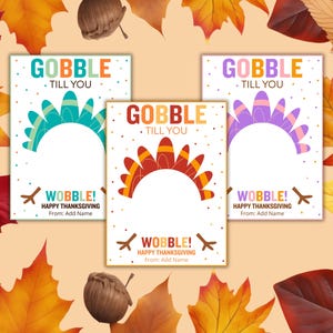 May include: Three Thanksgiving-themed cards with turkey feather designs in teal, orange, and purple. Each card has the text "GOBBLE TILL YOU" and "WOBBLE! HAPPY THANKSGIVING From: Add Name" on a white background, surrounded by fall leaves.