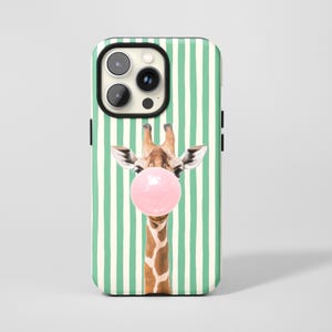 May include: A phone case featuring a giraffe blowing a pink bubblegum bubble. The giraffe's head and neck are centered on a background of vertical green and white stripes. The case has a black camera lens protector.