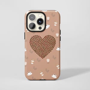 May include: A phone case with a brown background featuring a heart made of coffee beans. The case has a repeating pattern of coffee cups, coffee beans, and to-go coffee cups. The phone case has a black camera lens.