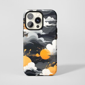 May include: A phone case with an abstract design. It features a dark background, grey and white clouds, and orange suns with splashes. The case has a black border and a camera cutout.