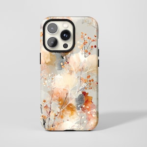 May include: A phone case with a floral pattern in beige, orange, and brown hues. The case has a black camera surround and a glossy finish. The design features stylized leaves and berries, giving a nature-inspired look.