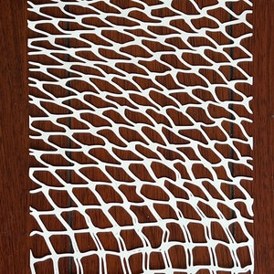 May include: White plastic mesh with a diamond pattern. The mesh is cut into a rectangular shape.