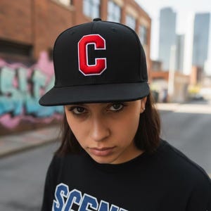 Professional embroidery machine stitching 3D puff varsity font on cap with foam underlay visible