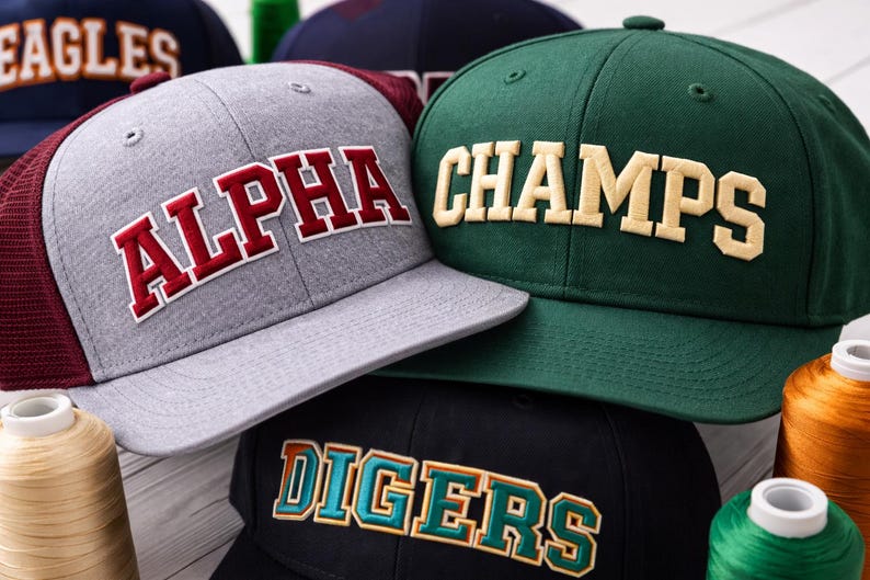 Arched college embroidery font stitched in 3D puff foam style on flat brim snapback hat