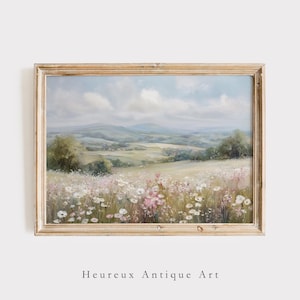 Puede incluir: Pintura de paisaje enmarcada que representa un campo de flores silvestres rosas y blancas, con colinas onduladas y un cielo nublado. La obra de arte está en un marco de madera, con el texto "Heureux Antique Art" en la parte inferior.