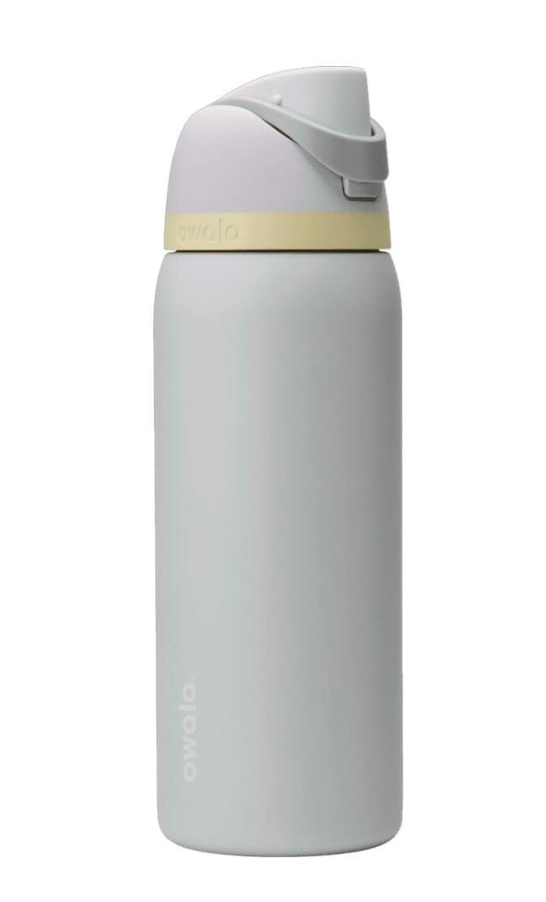 May include: A light blue water bottle with a white and gray lid and a yellow band. The bottle has the word "owala" printed on it. The bottle is cylindrical and appears to be made of plastic.