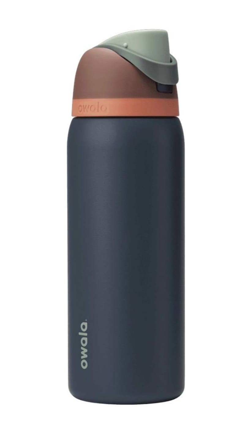May include: A navy blue insulated water bottle with a brown and orange lid and a green handle. The word "owala" is printed on the bottle. This reusable bottle is designed for hydration on the go.