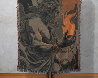 May include: A woven throw blanket featuring a detailed illustration of a muscular figure holding a flame. The artwork is in shades of gray, black, and orange, with a fringed edge. The figure is adorned with chains, creating a dramatic and artistic design.