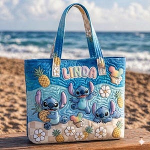 May include: Blue quilted tote bag featuring Stitch from Lilo & Stitch. The bag has a beach theme with Stitch characters, pineapples, and floral accents. The name "LINDA" is displayed on the front. The handles and bottom corners have a checkered pattern.