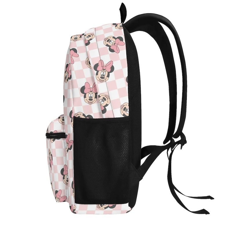 Peut inclure: Un sac &agrave; dos avec un motif &agrave; carreaux rose clair et blanc et une impression r&eacute;p&eacute;t&eacute;e de visages de Minnie Mouse. Le sac comprend une poche lat&eacute;rale en filet noir, des bretelles noires et un compartiment avant zipp&eacute; pour le rangement.