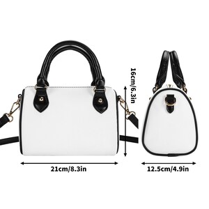 May include: White handbag with black accents, featuring a top handle and a detachable shoulder strap. The bag measures 8.3 inches long, 6.3 inches high, and 4.9 inches wide. Gold-colored hardware adds a touch of elegance to this stylish accessory.