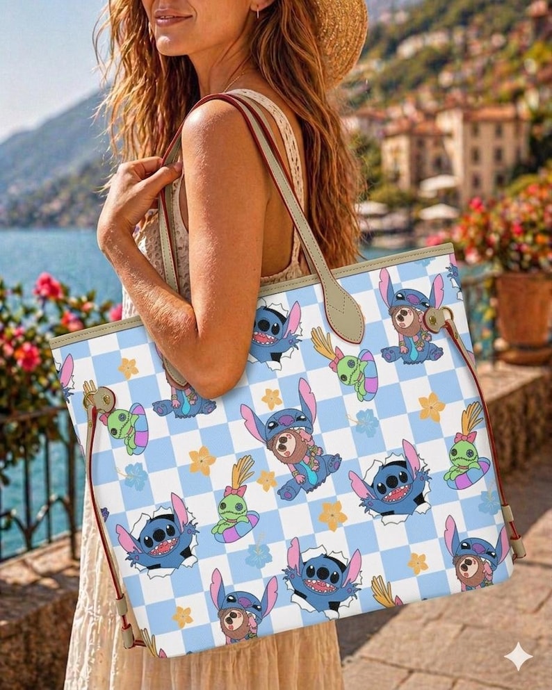 May include: A white tote bag with a blue and white checkered pattern featuring cartoon characters. The bag has brown handles and red trim. The cartoon characters are blue, green, and brown.