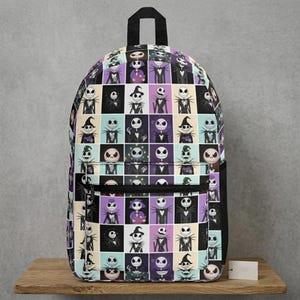 May include: A backpack featuring a grid pattern of various illustrations of Jack Skellington from The Nightmare Before Christmas. The design includes multiple poses and outfits in a color palette of black, white, purple, and light blue on a fabric bag.