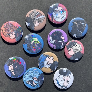May include: A collection of ten round buttons with anime-style character illustrations. The buttons feature various color schemes, including pink, blue, purple, and tan, with holographic accents. The illustrations depict characters in profile.