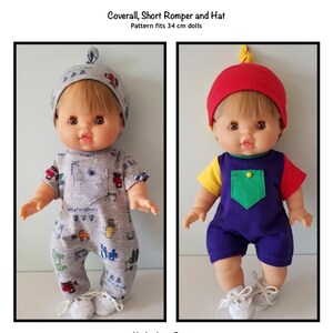 May include: Two dolls wearing different outfits. The doll on the left is wearing a gray romper with construction-themed graphics and a matching hat. The doll on the right is wearing a color-blocked outfit with a red hat. The text on the image says "Coverall, Short Romper and Hat" and "Pattern fits 34 cm dolls."