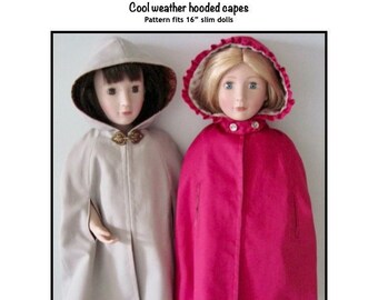 Pode incluir: Duas bonecas vestindo capas com capuz. A boneca à esquerda está vestindo uma capa cinza claro e a boneca à direita está vestindo uma capa rosa brilhante. O texto "Cool weather hooded capes" e "Pattern fits 16" slim dolls" é visível acima das bonecas. O texto "Kathy Anne Designs for dolls" é visível abaixo das bonecas.