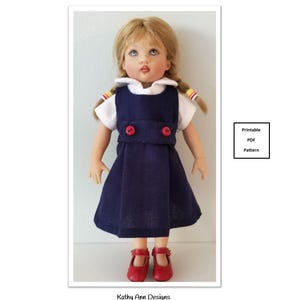May include: A doll wearing a white collared shirt under a navy blue jumper dress with two red buttons at the waist and red shoes. The doll has blonde hair in braids. Text reads: School Uniform, Pattern fits 7" dolls, Printable PDF Pattern, Kathy Ann Designs For dolls.