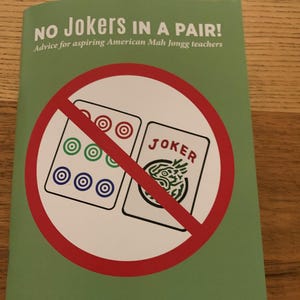 May include: A green book cover with the title "NO Jokers IN A PAIR!" and the subtitle "Advice for aspiring American Mah Jongg teachers." The cover features a red circle with a line through two Mah Jongg tiles. The author's name is Alice Stern.