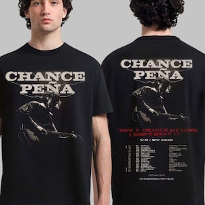May include: Black t-shirt with the text "CHANCE PENA" in white, and a graphic of a person playing a guitar. The back of the shirt also has the text "CHANCE PENA", a graphic, and tour dates.