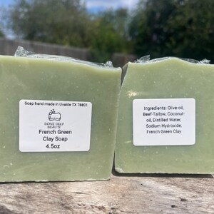 May include: Two bars of French Green Clay Soap, each wrapped in clear plastic. The soap is a pale green color and has a label that reads "French Green Clay Soap 4.5oz." Ingredients include olive oil and French green clay.