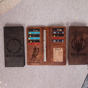 May include: Three leather wallets in shades of brown. One closed wallet is dark brown with a circular design and the name "RICHARD". The open wallet is tan with card slots and a bill compartment. The third wallet is brown with a vertical design and the name "RICHARD".