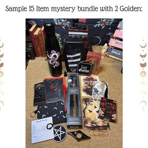 May include: A collection of gothic-themed items, including a black water bottle with a pink dragon design, a black coffin-shaped box, and a small sign that says "Sorry Goths". Other items include a black pouch with bats, a pentagram patch, and a tarot card.