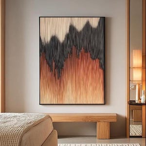 May include: Abstract wall art in a black frame. The artwork has a textured design with vertical lines in beige, black, and orange. It hangs above a wooden bench in a neutral-toned room, creating a modern aesthetic.