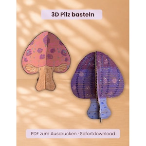 Pode incluir: Dois cogumelos 3D feitos de papelão. Um cogumelo é rosa com manchas roxas e um caule bege, enquanto o outro é roxo com um padrão de grade e um caule azul. O texto 3D Pilz basteln e PDF zum Ausdrucken Sofortdownload é visível.