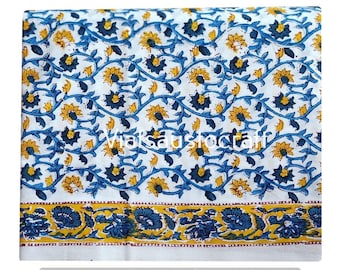 May include: White fabric with a repeating pattern of yellow sunflowers and blue vines. A border of blue floral designs on a yellow background accents the bottom edge. The text "Viatasutocraft" is visible on the fabric.