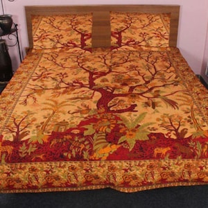 May include: Bed linen set with a tree of life design in orange, red, and green. The bedspread and two pillowcases have a detailed border. The set is made of a soft fabric.