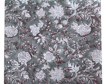 May include: A fabric with a floral pattern. The design features white flowers and leaves with dark red outlines on a gray background. The pattern is repeated across the fabric, creating a cohesive design.