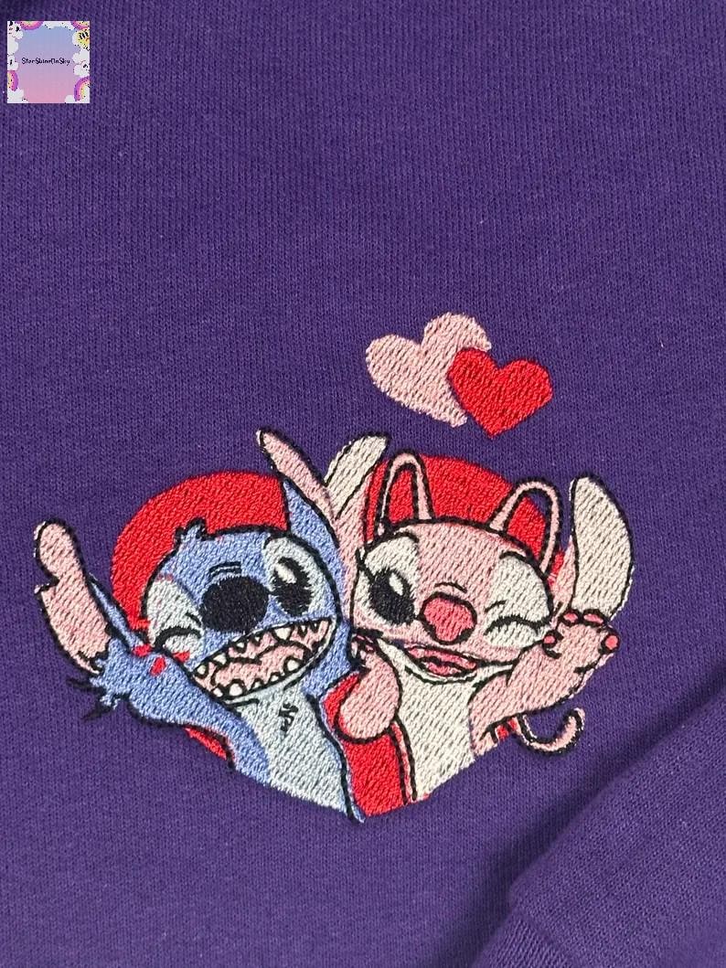 two cartoon characters, a blue one and a pink one, who appear to be in a loving embrace.